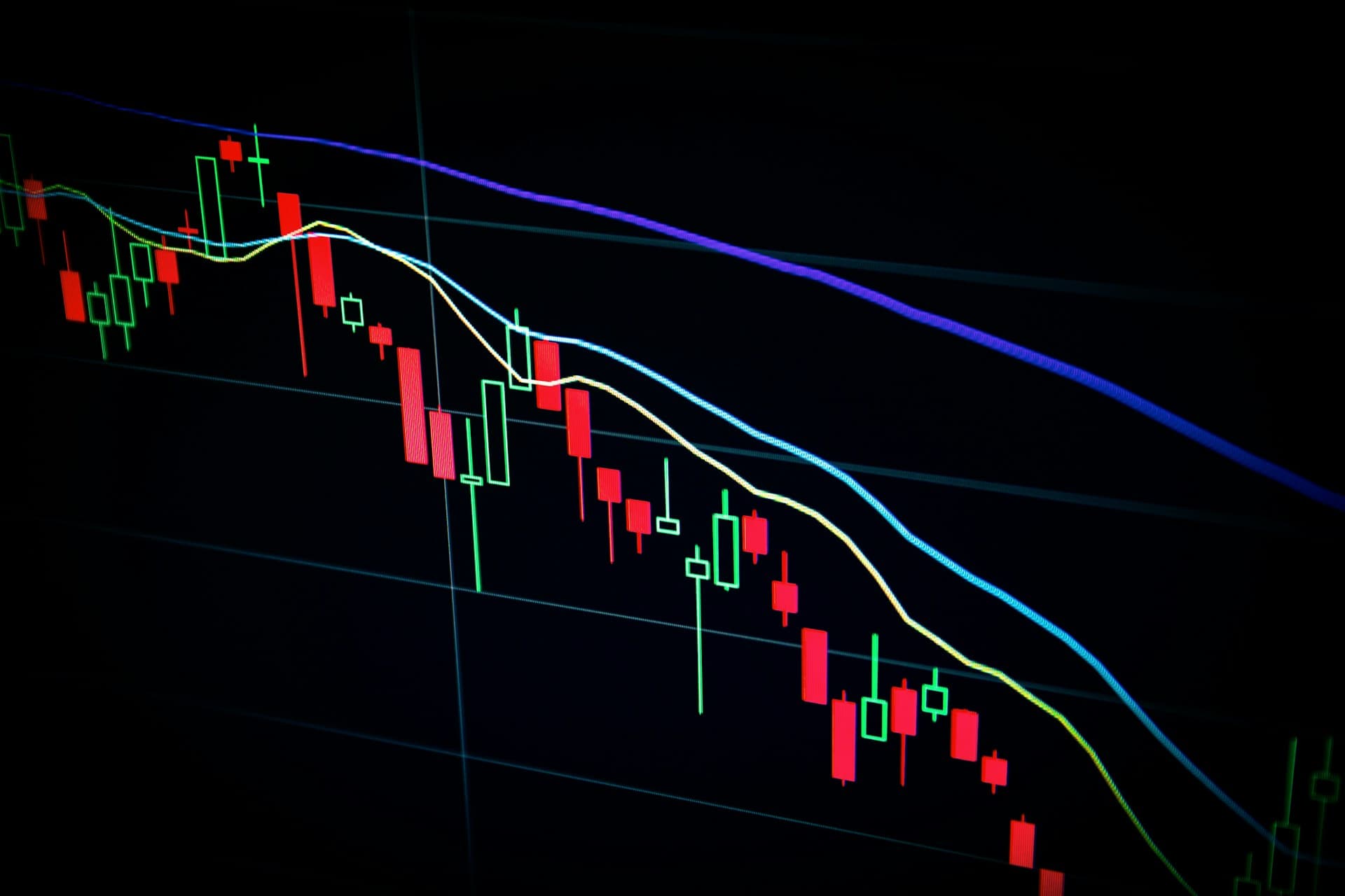 Stock market candlestick chart on dark screen